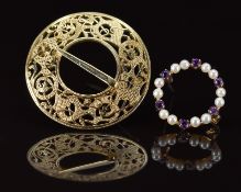 A 14k gold brooch in a pierced Celtic design (8.8g, 3.2cm) and a 9ct gold brooch set with pearls and