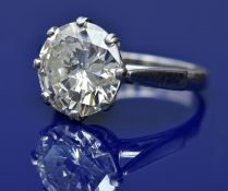 A platinum ring set with a round brilliant cut diamond of approximately 6.7ct, with AnchorCert