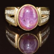 A 9k gold ring set with a star ruby cabochon and diamonds, 6.2g, size N