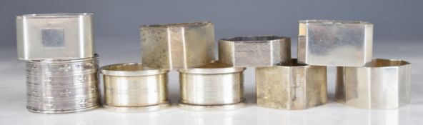 Nine various hallmarked silver napkin rings including engine turned examples and a triangular Art