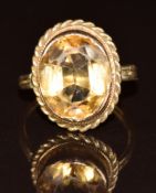 A 9ct gold ring set with an oval cut citrine, 3.8g, size F