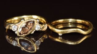 A bespoke 18ct gold ring set with a marquise cut champagne diamond of approximately 1ct and two