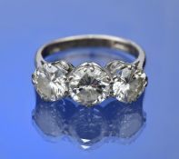 An 18ct white gold ring set with three round brilliant cut diamonds of approximately 1.2ct, 1ct