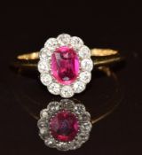 An 18ct gold ring set with an oval cut synthetic pink sapphire of approximately 0.7ct surrounded
