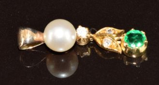 A 9ct pendant set with a round cut emerald of approximately 0.3ct, old cut diamonds and a cultured