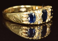 An 18ct gold ring set with three oval cut sapphires and six diamonds, 5.3g, size N