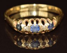 A c1920 18ct gold ring set with three sapphires and two diamonds, 2.7g, size S