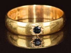 A 22ct gold wedding band / ring set with a sapphire in star setting, Birmingham 1926, size Q, 4.3g