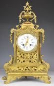 Ornate pierced brass mantel clock with enamelled Roman numerals and numbered movement striking on