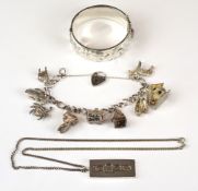A silver charm bracelet with nine charms including treasure chest, horse, crab, etc, a silver bangle