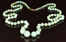 A beaded necklace made up of graduated round jadeite beads with 9ct gold barrel clasp, largest