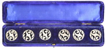 A set of six white metal buttons set with paste, in original box, length 23cm