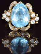 An 18k gold ring set with a pear cut topaz and cubic zirconia, 7.8g, size N
