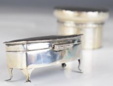 Two hallmarked silver dressing table pots, one raised on four feet, with silk interior, Birmingham