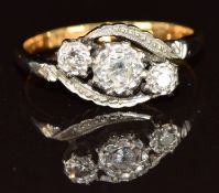 An 18ct gold ring set with three diamonds in a platinum twist setting, 3.2g, size K/L