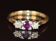 A 9ct gold ring set with a ruby and diamonds, 2.4g, size M
