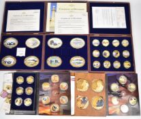 Seven gold plated picture coin sets, most relating to WW2, some in wooden cases and others in