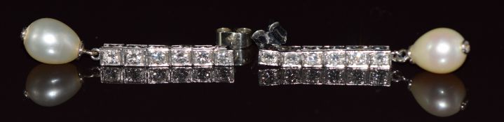 A pair of platinum drop earrings each set with six round brilliant cut diamonds of approximately 0.