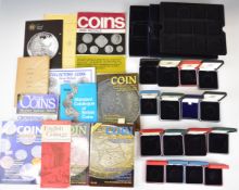 A quantity of coin reference books incluidng Seaby, together with a collection of empty Royal Mint