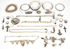 A collection of silver jewellery including for bangles one by Charles Horner, charm bracelet with