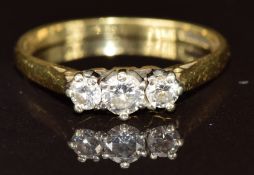 An 18ct gold ring set with three diamonds, 2.1g, size K/L