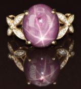 A 9k gold ring set with a star ruby cabochon and diamonds, 3.9g, size L