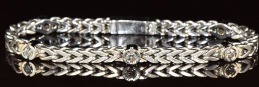 An 18ct white gold bracelet set with five round cut diamonds, each approximately 0.15ct, 29.4g,