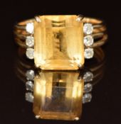 An 18ct gold ring set with an emerald cut citrine and diamonds, 4.6g, size N