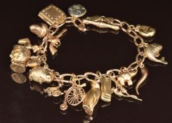 A 9ct gold charm bracelet with seventeen 9ct gold charms including gun, pig, penguin, etc, 29g