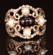A 9ct gold ring set with a garnet cabochon and pearls, 5.1g, size N