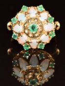 A 14k gold ring set with opals and emeralds in a cluster, 6.6g, size O