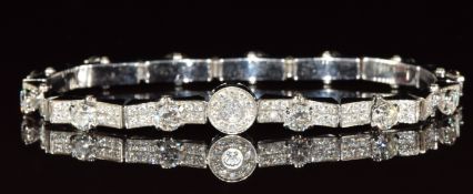 An 18ct white gold bracelet set with diamonds, the curved pavé set diamond panels each with a