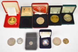 A group of mainly cased coins including three Isle of Man examples, one silver