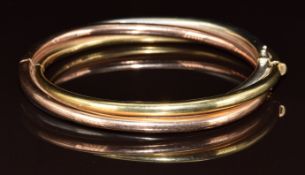 A 9ct gold tri-coloured bangle, 26.7g, 6.2 x 5cm