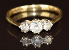 An 18ct gold ring set with three diamonds, 2.1g, size N