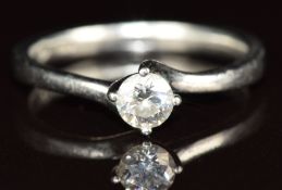 A platinum ring set with a round cut diamond of approximately 0.26ct, 3.5g, size K