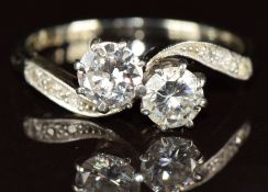An 18ct gold ring set with two diamonds of approximately 0.35ct & 0.4ct in a twist setting and