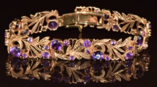 A 9ct gold bracelet in a pierced foliate design set with round cut amethysts, 22g, 17.5cm