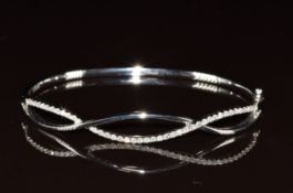A 9ct white gold bangle set with diamonds, 12g, 6 x 5cm