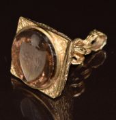 A 9ct gold seal set with a carved smoky quartz intaglio seal depicting a crest, 14.6g