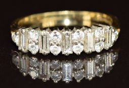 An 18ct gold ring set with baguette cut and round cut diamonds, 2.3g, size I