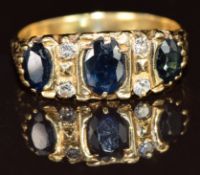 An 18ct gold ring set with three sapphires and four diamonds, 5g, size O