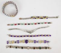 Seven silver bracelets set with sapphires, topaz, tourmaline, amethyst, garnet, peridot, citrine,
