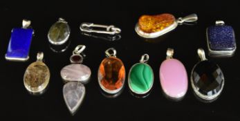 Eleven silver pendants including pressed amber, faux sunstone, rose quartz, lapis lazuli, rutile