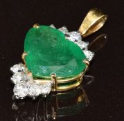 An 18ct gold pendant set with a heart cut emerald of approximately 3ct and diamonds, 3.6g