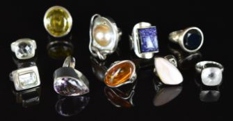 Ten silver rings including citrine, amethyst, pearl, pressed amber, aquamarine, etc, 112g