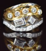 An 18ct gold bi coloured ring set with a baguette cut diamond of approximately 0.3ct, a princess cut