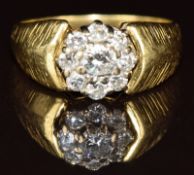 An 18ct gold ring set with diamonds in a cluster, the centre diamond approximately 0.12ct, 3.5g,