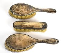 Three hallmarked silver backed brushes, length of longest 23cm
