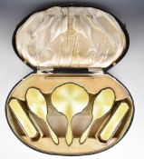 Art Deco cased hallmarked silver and yellow guilloché enamel dressing table set comprising hand